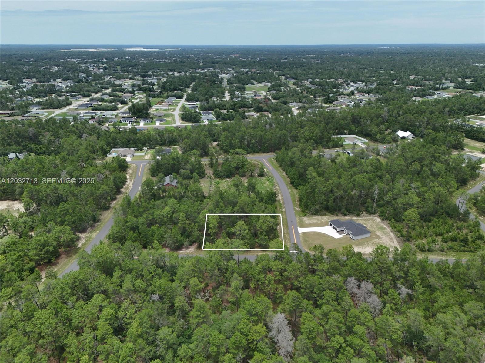 An aerial view shows a rectangular vacant lot outlined in white within a wooded area — 0 SW 40th Ct, Ocala FL 34473, OCALA, FL