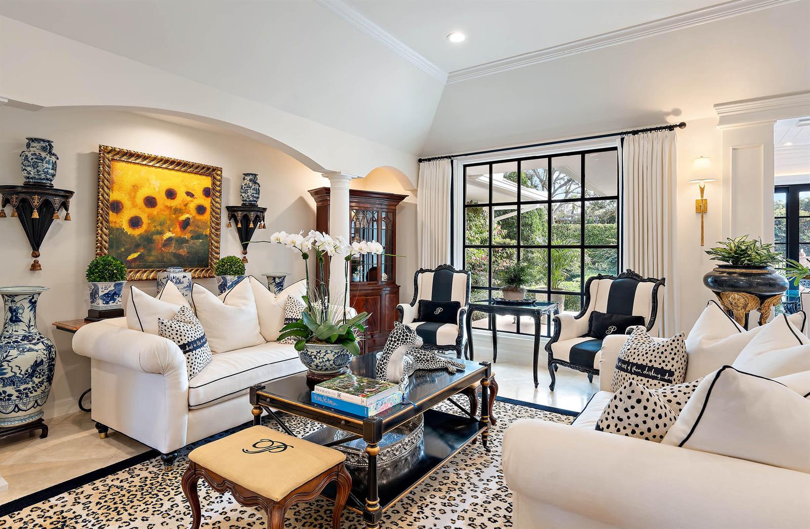 A living room features white sofas, a black coffee table, and a large grid window — 11818 Lost Tree Way, North Palm Beach FL 33408, NORTH PALM BEACH, FL