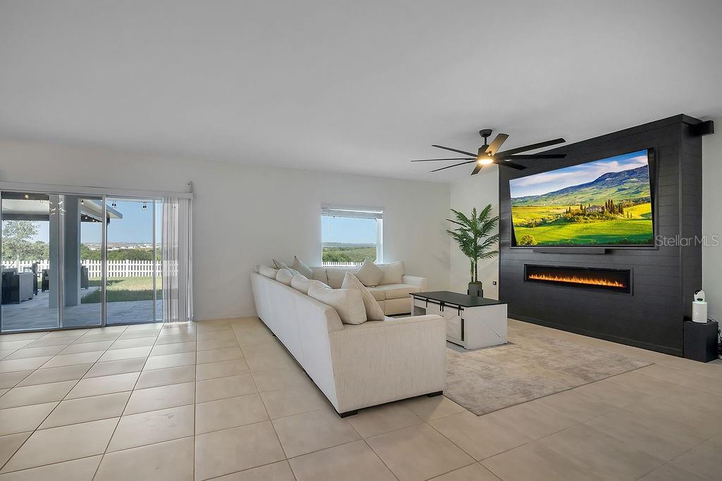 A two-story light gray house with a two-car garage and a front lawn — 1033 CALICO POINTE CIRCLE, GROVELAND, FL