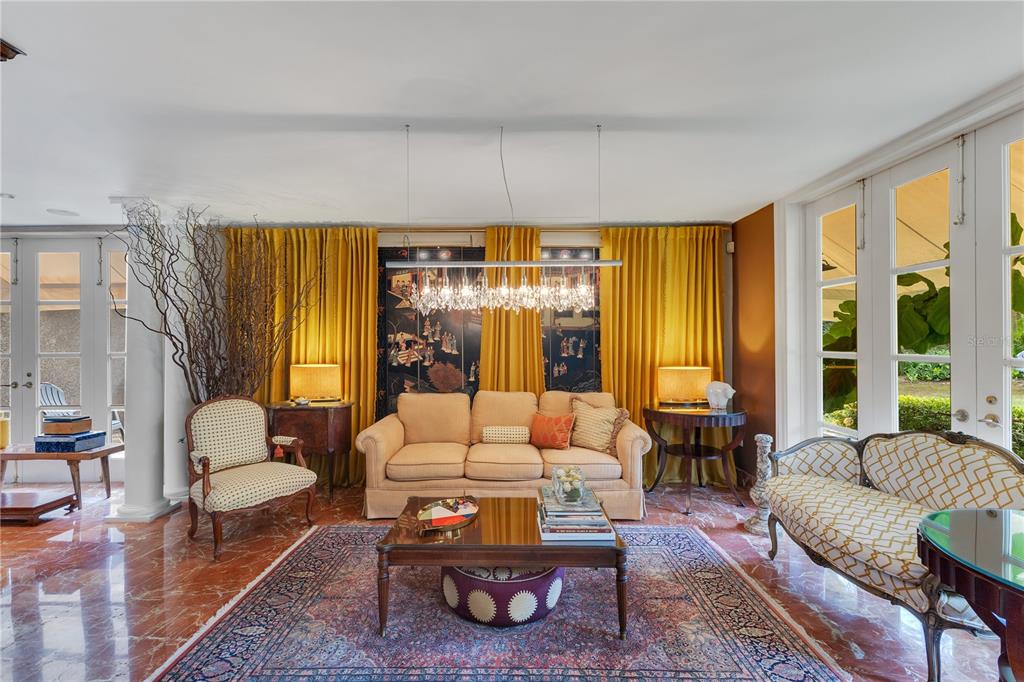 A living room features a beige sofa, patterned armchairs, a crystal chandelier, and yellow curtains — A2 MONTEBELLO STREET, GUAYNABO, PR