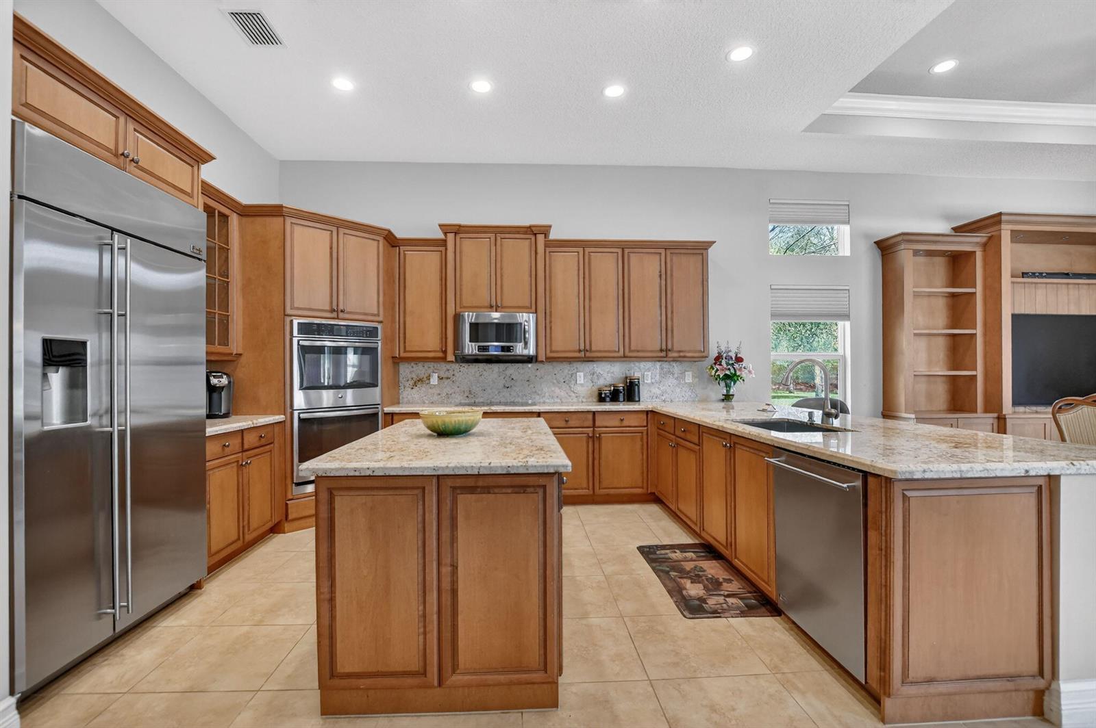A kitchen with wood cabinets, granite countertops, stainless steel appliances, and a central island — 12133 Glacier Bay Drive, Boynton Beach FL 33473, BOYNTON BEACH, FL