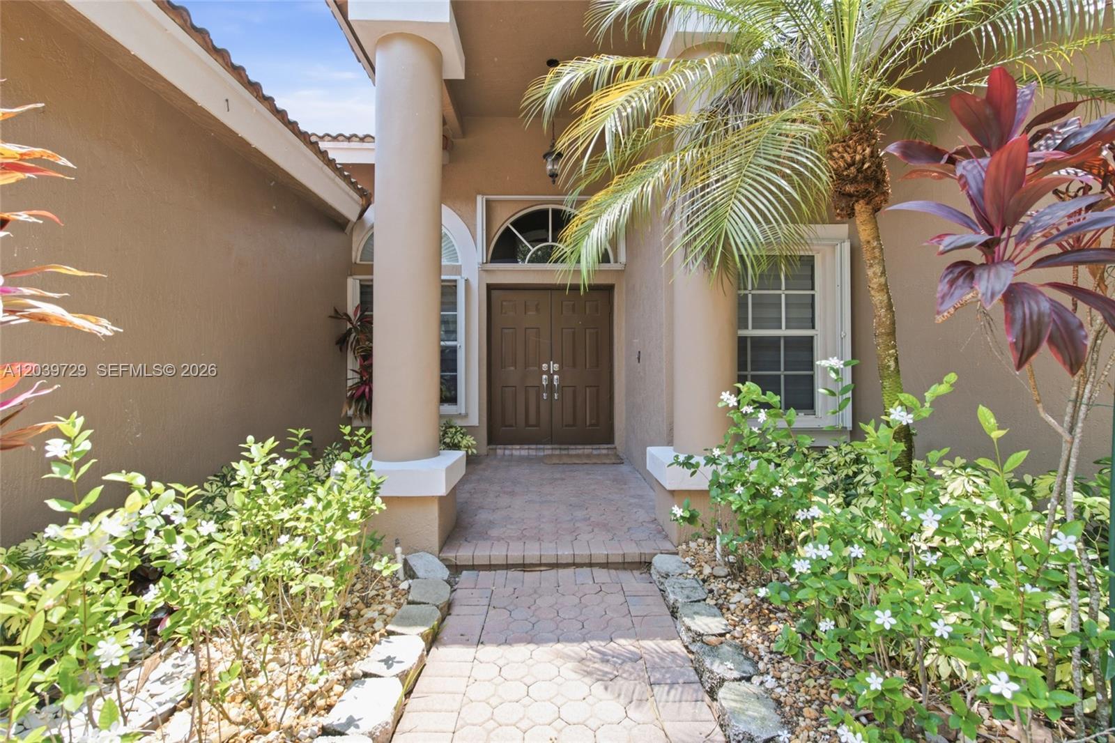 A paved walkway leads to a double-door entrance framed by two large columns — 3725 Oak Ridge Ln, Weston FL 33331, WESTON, FL