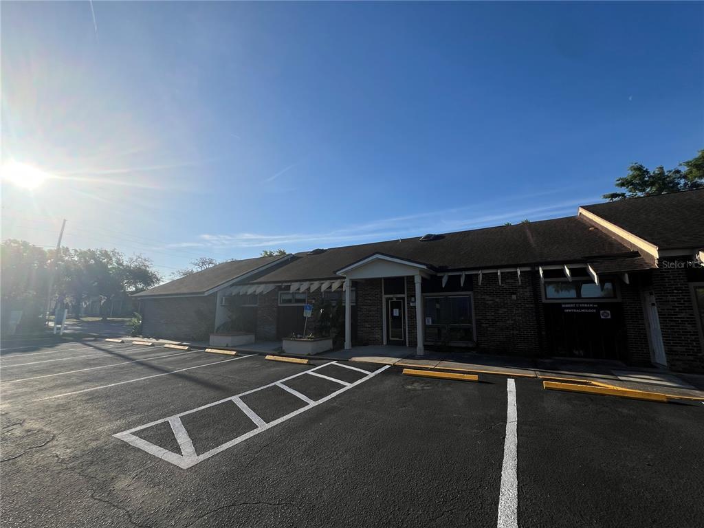 A single-story brick commercial building with a parking lot in the foreground — 5427 WATER STREET, NEW PORT RICHEY, FL