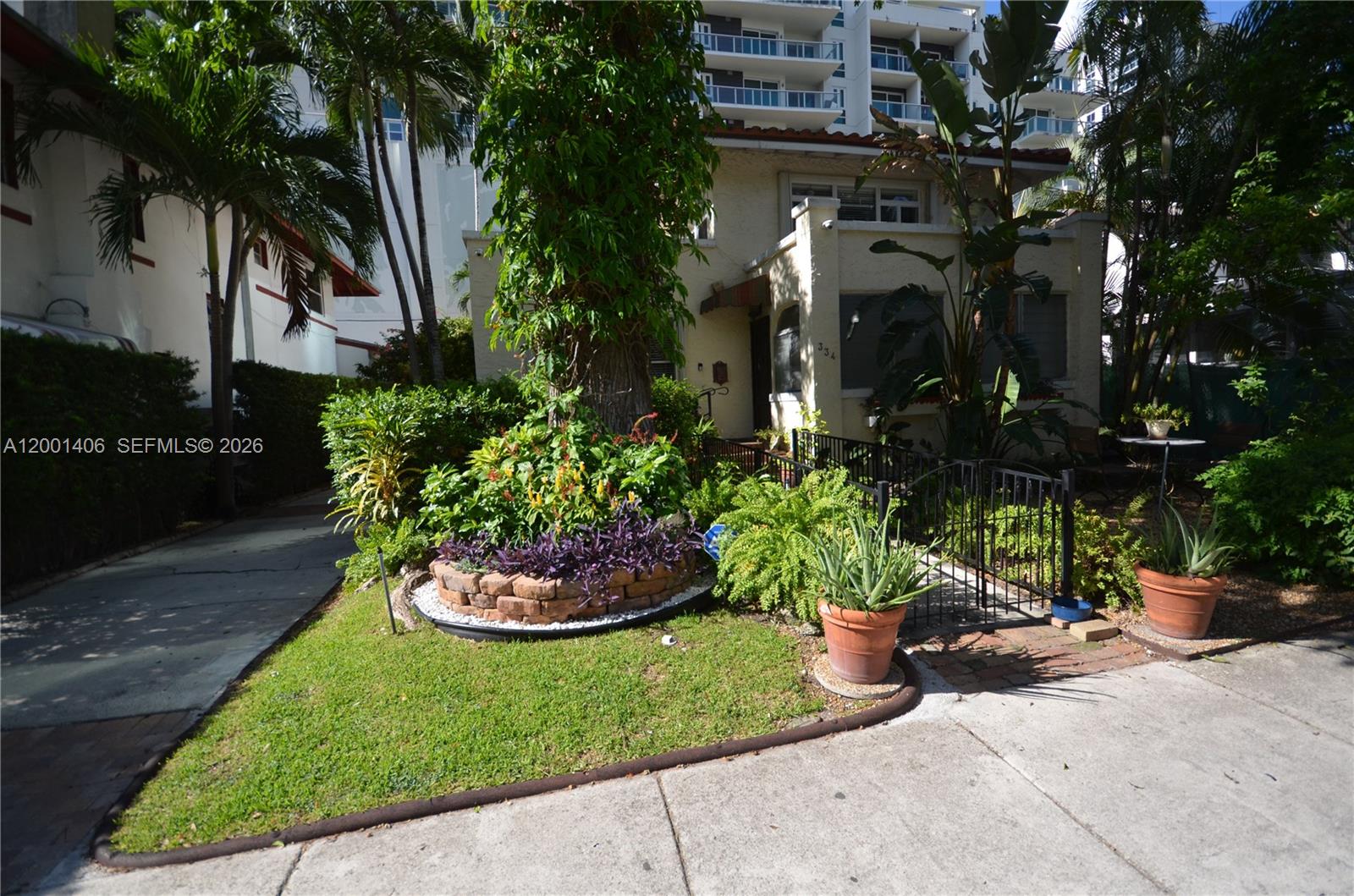 A two-story house with a landscaped front yard and a brick-bordered garden bed — 334 NE 26th Ter, Miami FL 33137, MIAMI, FL