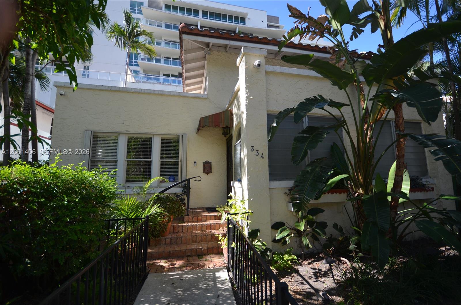A single-story stucco house with a brick staircase and tropical landscaping — 334 NE 26th Ter, Miami FL 33137, MIAMI, FL
