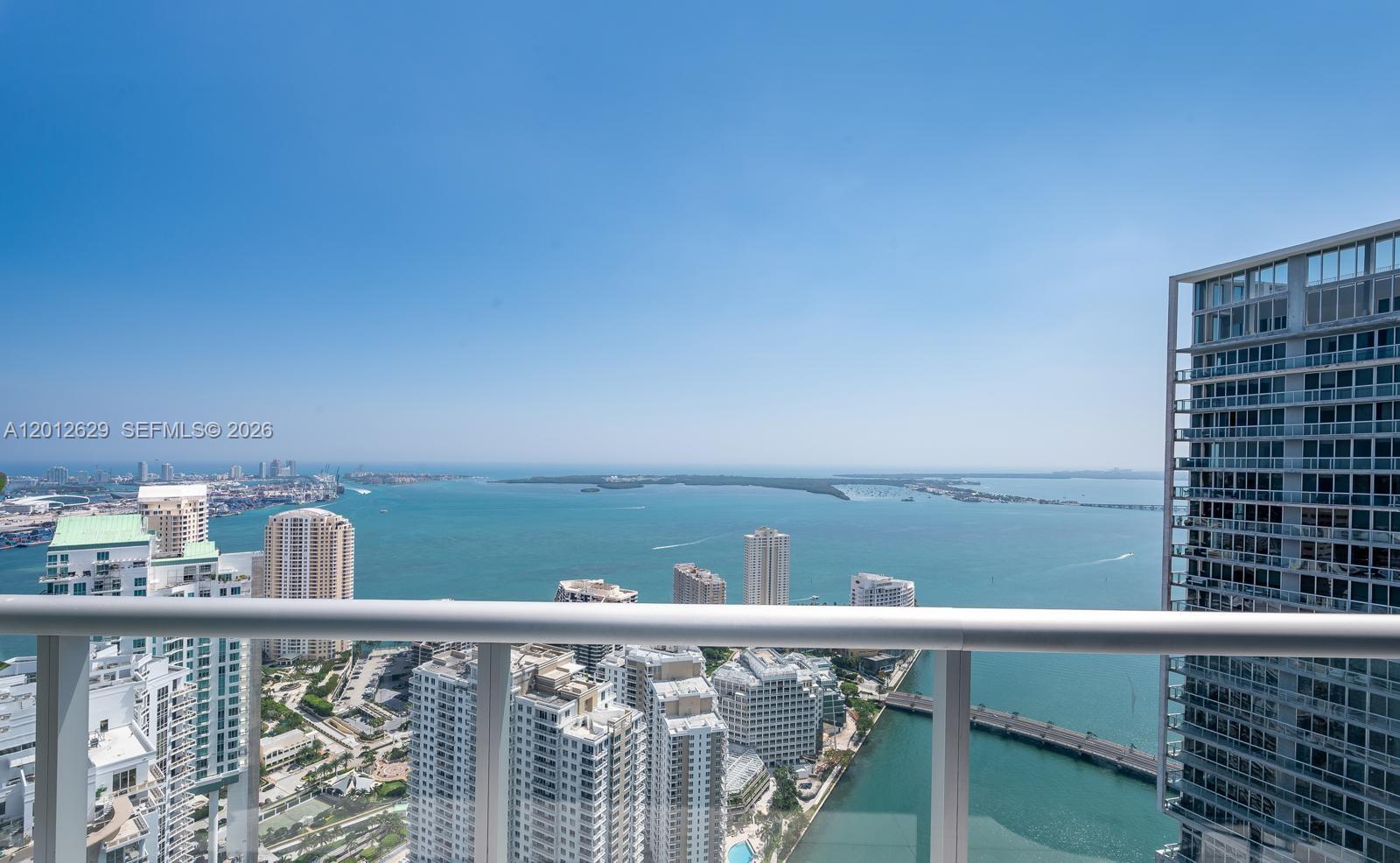 A high-rise balcony overlooks a bay with city buildings and a bridge — 465 E Brickell Ave # 5305, Miami FL 33131, MIAMI, FL