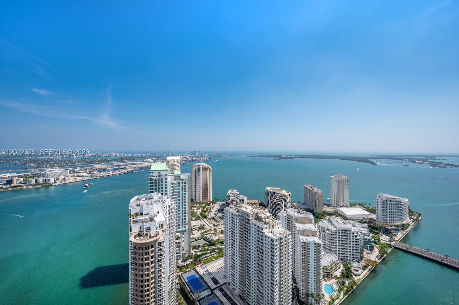 An aerial view of high-rise buildings on a waterfront peninsula surrounded by the ocean — 465 E Brickell Ave # 5305, Miami FL 33131, MIAMI, FL