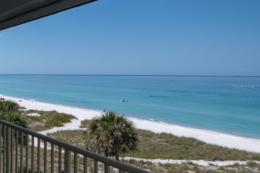 A view of a white sand beach and turquoise ocean from a balcony — 4325 GULF OF MEXICO DRIVE UNIT 507, LONGBOAT KEY, FL