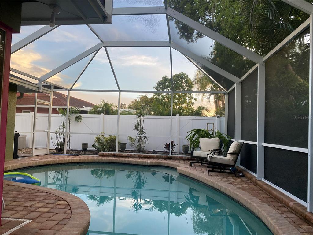 An aerial view shows a single-story house with a paved driveway and gravel front yard — 1833 OAK VIEW DRIVE, SARASOTA, FL