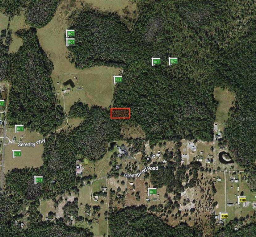 This is an aerial map showing a rectangular property highlighted in red amidst wooded land — POLK CITY, POLK CITY, FL