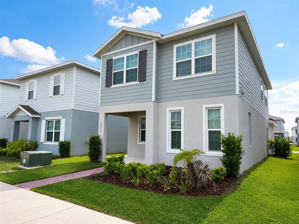 A two-story house with light blue siding and a gray stucco lower level exterior — 3974 GREAT SMOKEY WAY, APOPKA, FL
