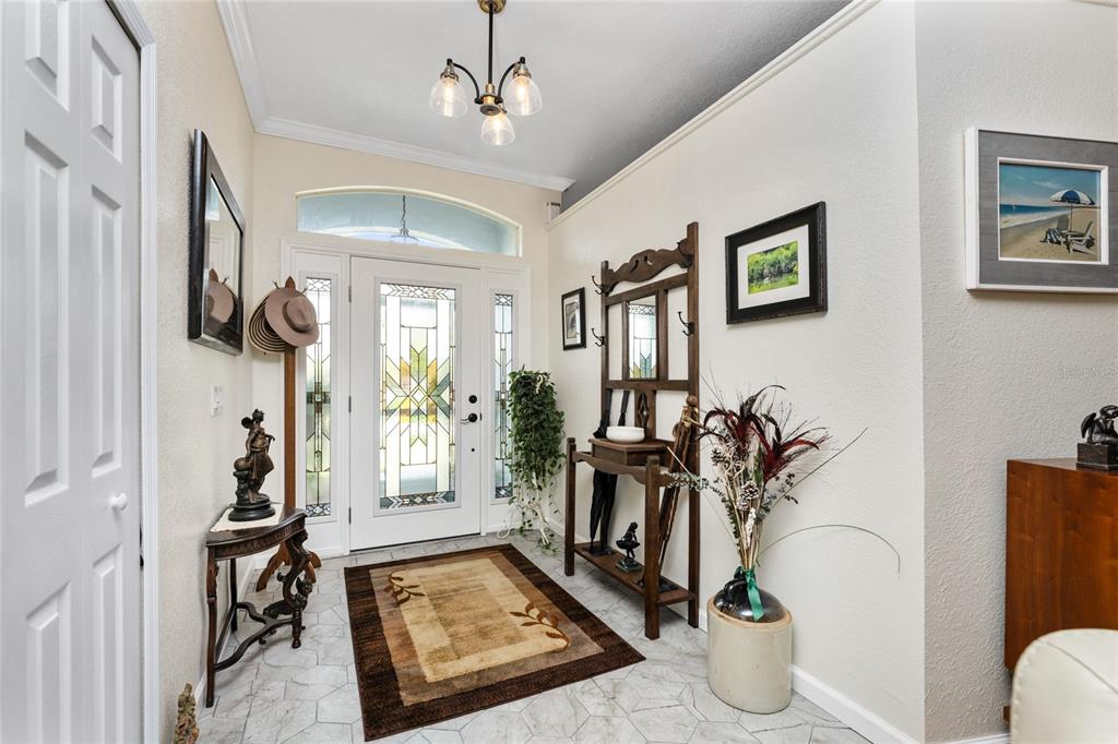 An entryway features a stained glass front door, tile flooring, and a wooden hall tree — 15105 ALDAMA CIRCLE, PORT CHARLOTTE, FL