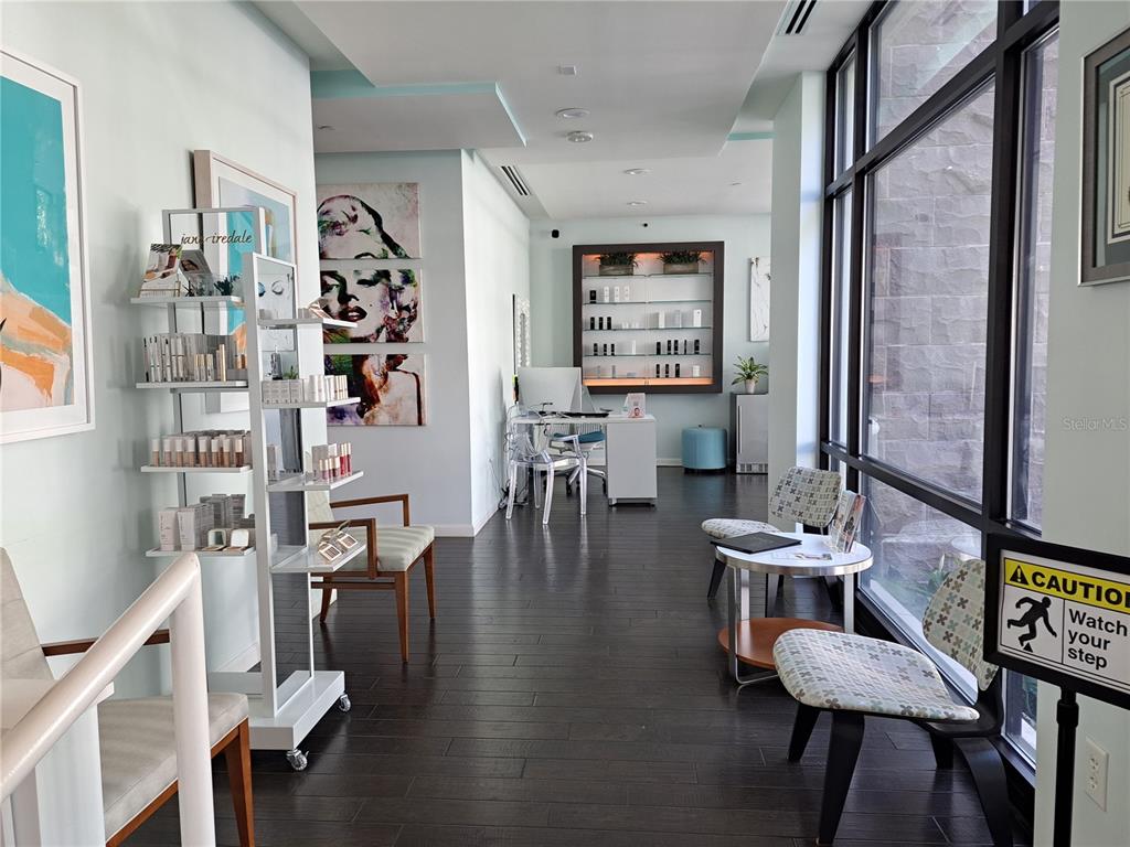 A bright waiting area features dark wood flooring, product display shelves, and large windows — 330 W MORSE BLVD UNIT 104, WINTER PARK, FL