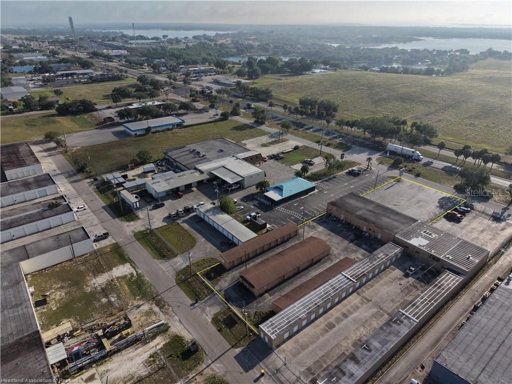 An aerial view shows a commercial property with multiple storage buildings and parking lots — 708 US 27 S, LAKE PLACID, FL