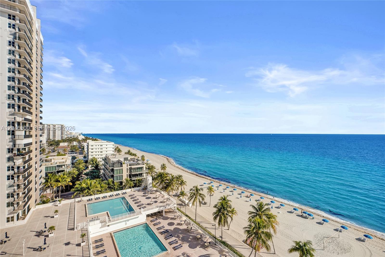 An elevated view shows a beach, ocean, and swimming pools next to a tall building — 2301 S Ocean Dr # 1004, Hollywood FL 33019, HOLLYWOOD, FL