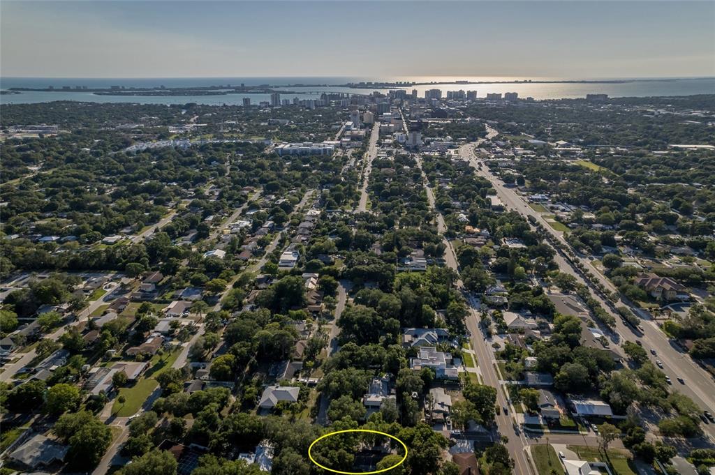 An aerial view of a residential neighborhood with a yellow circle highlighting a property — 95 S BRIGGS AVENUE, SARASOTA, FL