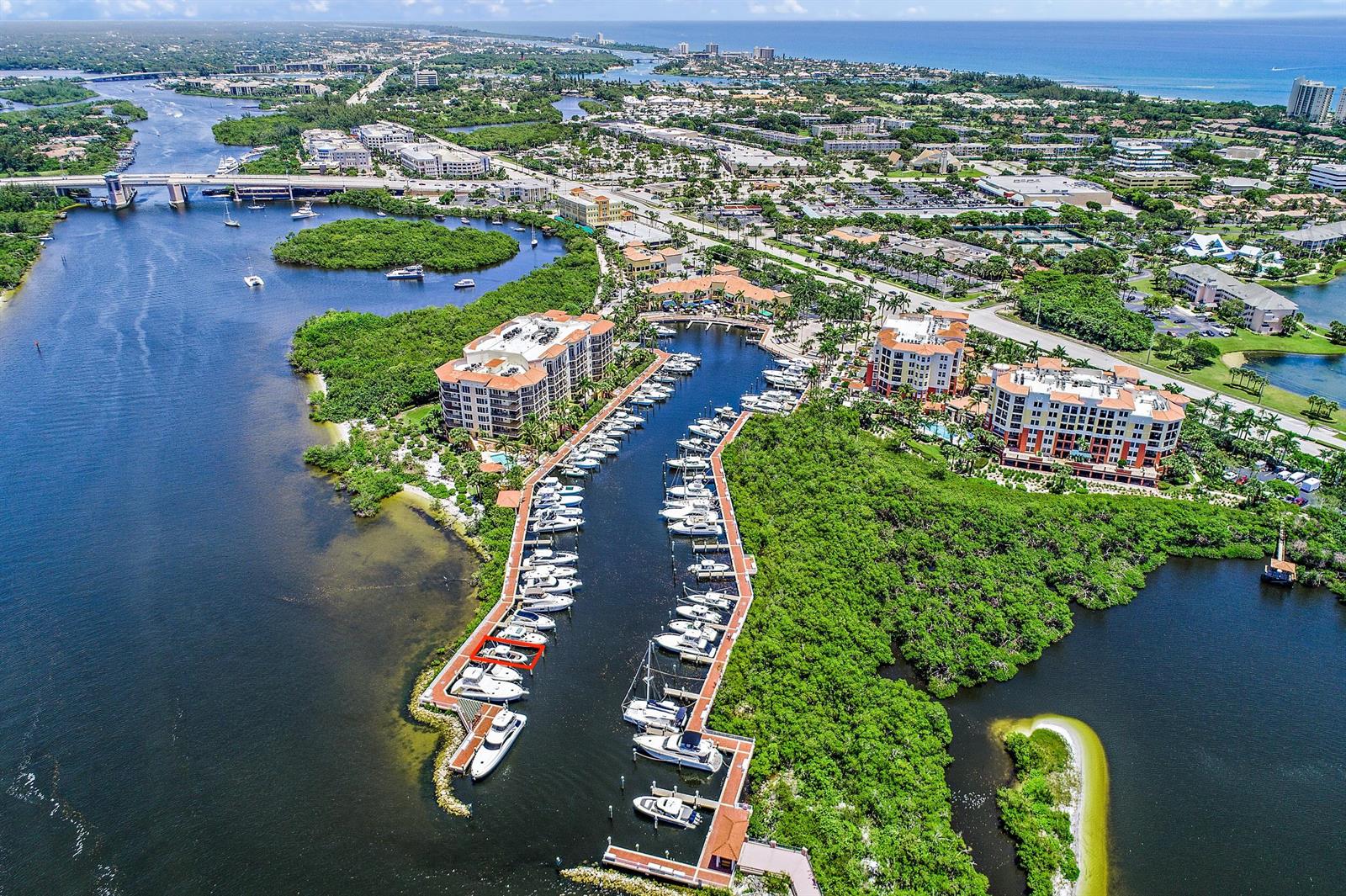 An aerial view shows a marina with docked boats surrounded by lush vegetation and buildings — 348 S Us Highway 1, Jupiter FL 33477, JUPITER, FL