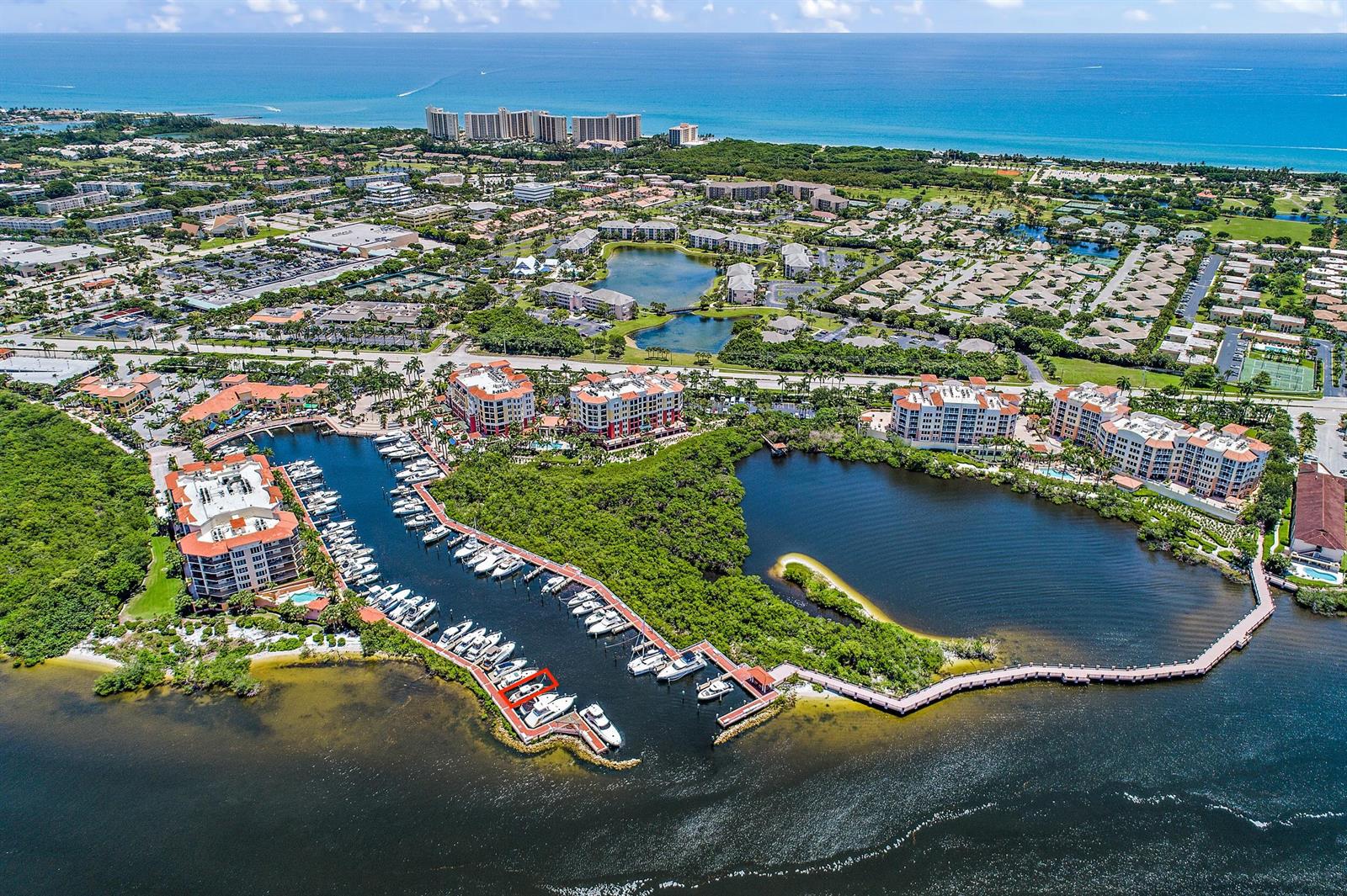 Aerial view of a marina with docked boats surrounded by residential buildings and lush vegetation — 348 S Us Highway 1, Jupiter FL 33477, JUPITER, FL