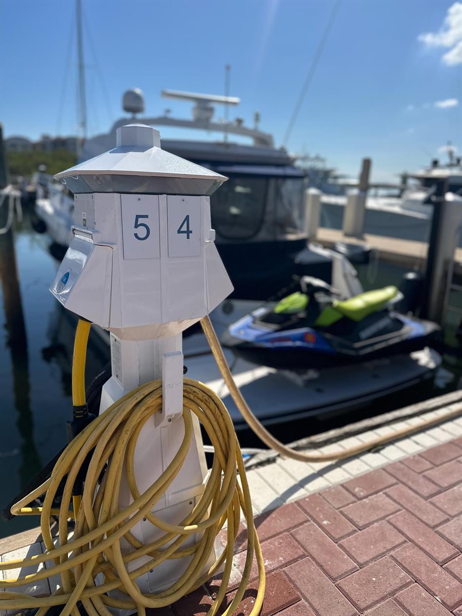A white utility pedestal labeled 54 stands on a dock next to a boat — 348 S Us Highway 1, Jupiter FL 33477, JUPITER, FL