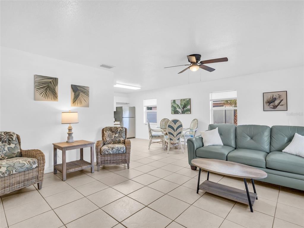 A living room and dining area with tile floors, a ceiling fan, and neutral walls — 103 E PARK STREET, TARPON SPRINGS, FL