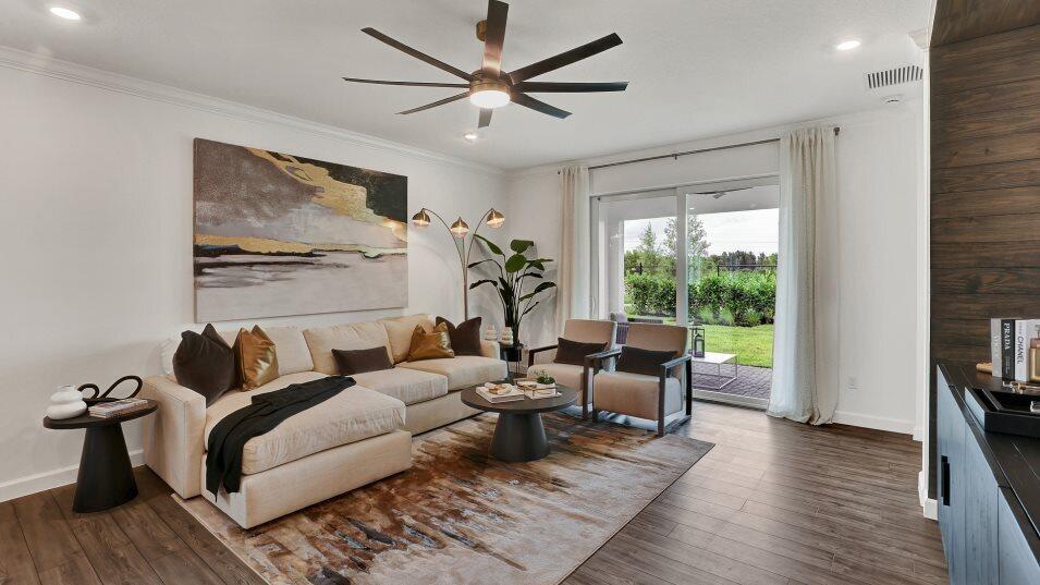 A living room features a beige sectional, two armchairs, a large area rug, and sliding doors — 1699 Pelican Post Place, FL 33470, FL
