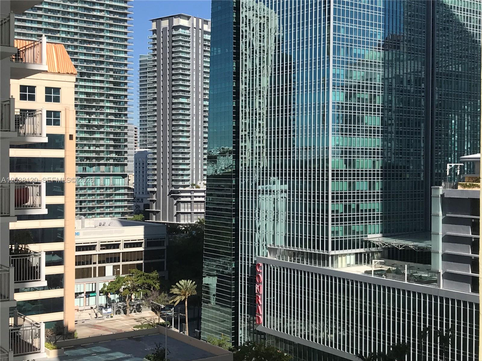 An exterior view of several modern high-rise buildings in a dense urban setting — 185 SE 14th Ter # 1401, Miami FL 33131, MIAMI, FL