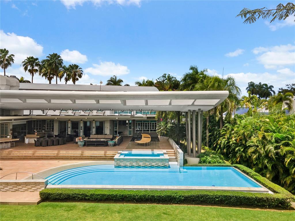 A modern house exterior features a large swimming pool, a hot tub, and a covered patio — 9 CASTAÑA STREET, GUAYNABO, PR