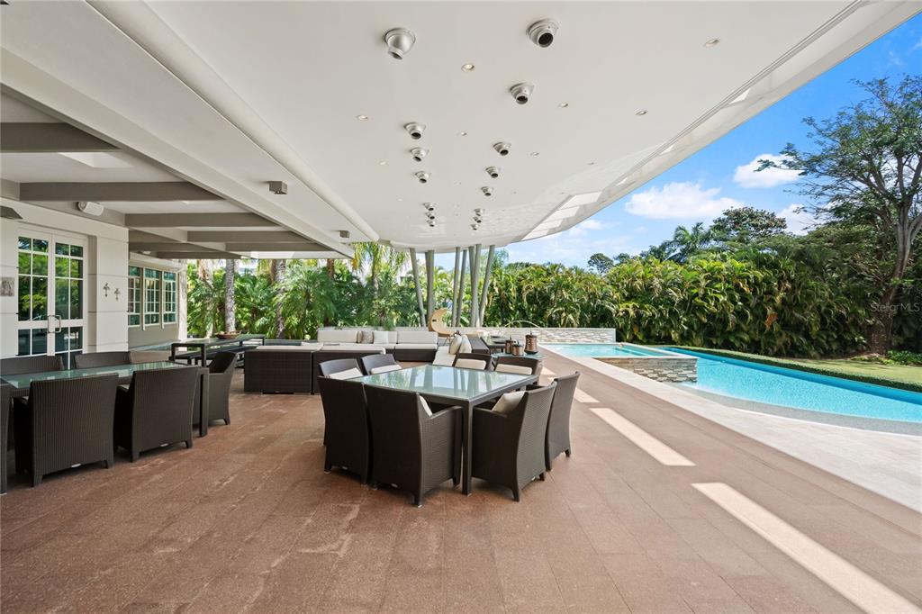 A covered outdoor patio features dining sets, lounge seating, and a swimming pool with spa — 9 CASTAÑA STREET, GUAYNABO, PR