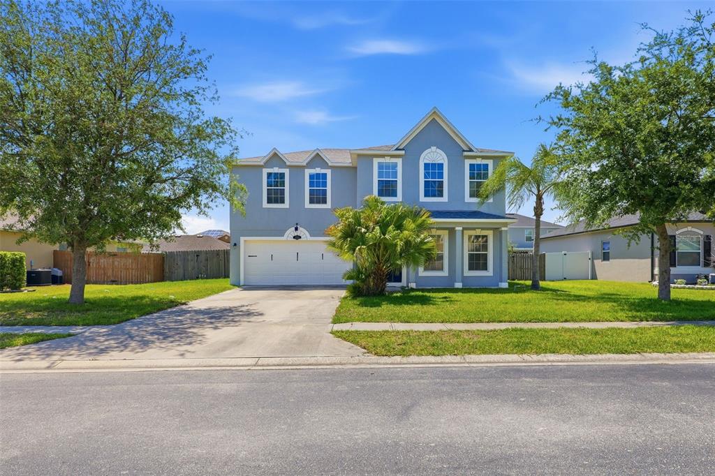 A two-story blue house with a two-car garage and a front lawn — 3356 SLATE STREET, WEST MELBOURNE, FL
