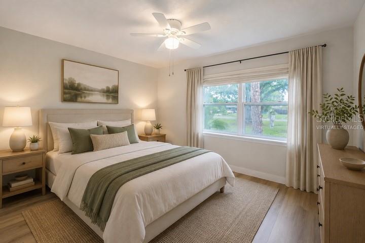 A staged bedroom features a queen bed, two nightstands, a dresser, and a ceiling fan — 314 4TH AVENUE SW, RUSKIN, FL