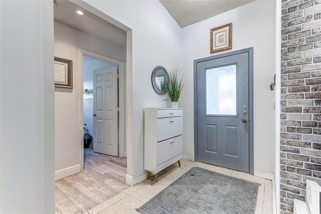 A living room and dining area feature a grey sectional sofa, glass tables, and tile flooring — 7813 TURKEY OAK LANE, KISSIMMEE, FL