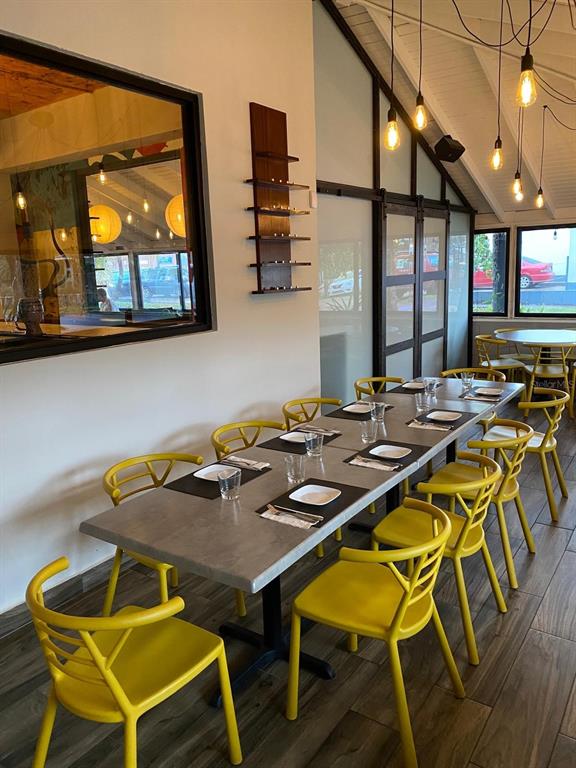 A dining room features a long gray table with yellow chairs and pendant lighting — Punta Las Marias 33 & 35 CAOBA, SAN JUAN, PR