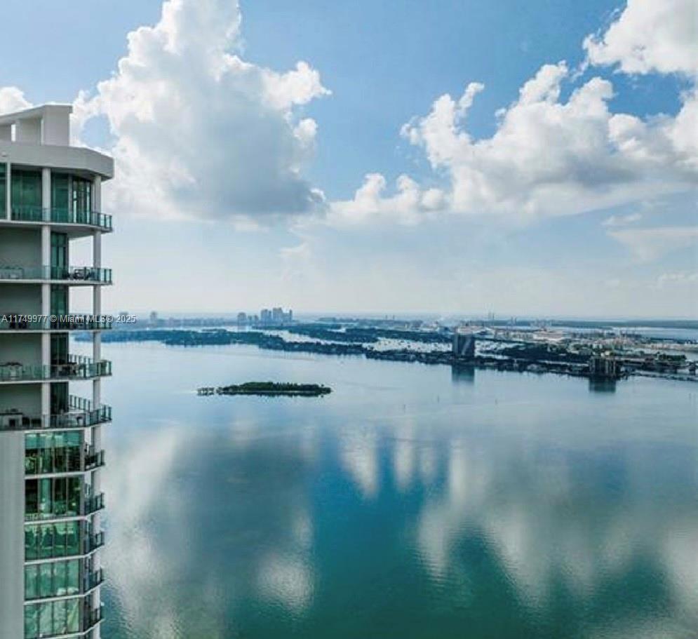 A high-angle view shows a modern residential building overlooking a bay with small islands — 2900 NE 7th Ave # 1601, Miami FL 33137, MIAMI, FL