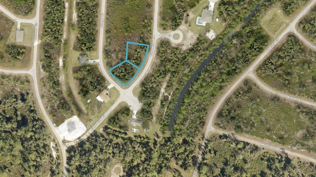 This aerial map shows two adjacent vacant lots highlighted in blue along a residential street — 1148203707 & 1148203708 CAPE COD ROAD, NORTH PORT, FL
