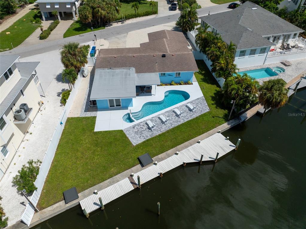 An aerial view of a waterfront home featuring a swimming pool, patio, and private dock — 507 59TH STREET, BRADENTON BEACH, FL