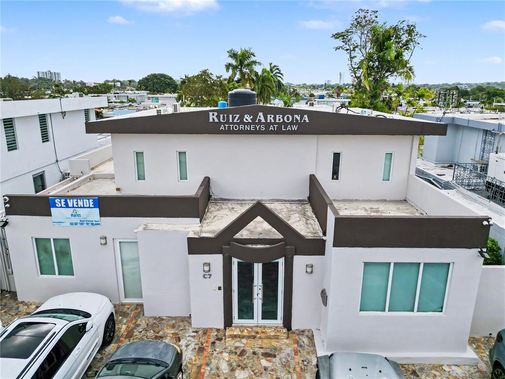 An exterior view of a two-story building with a brown and white facade — C7 AVE ACUARELA, GUAYNABO, PR