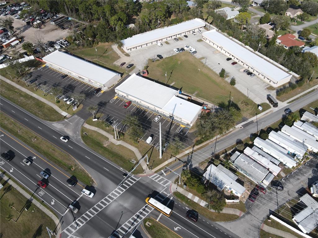 Aerial view of a commercial complex with multiple buildings, parking lots, and surrounding roads — 2111 S RIDGEWOOD AVENUE, EDGEWATER, FL