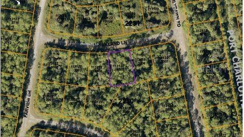 This is an aerial map view showing a highlighted vacant lot in a residential area — PINKLADY LANE, NORTH PORT, FL