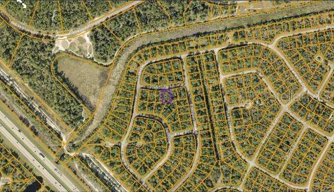 This is an aerial map showing a residential neighborhood with a highlighted vacant lot — PINKLADY LANE, NORTH PORT, FL