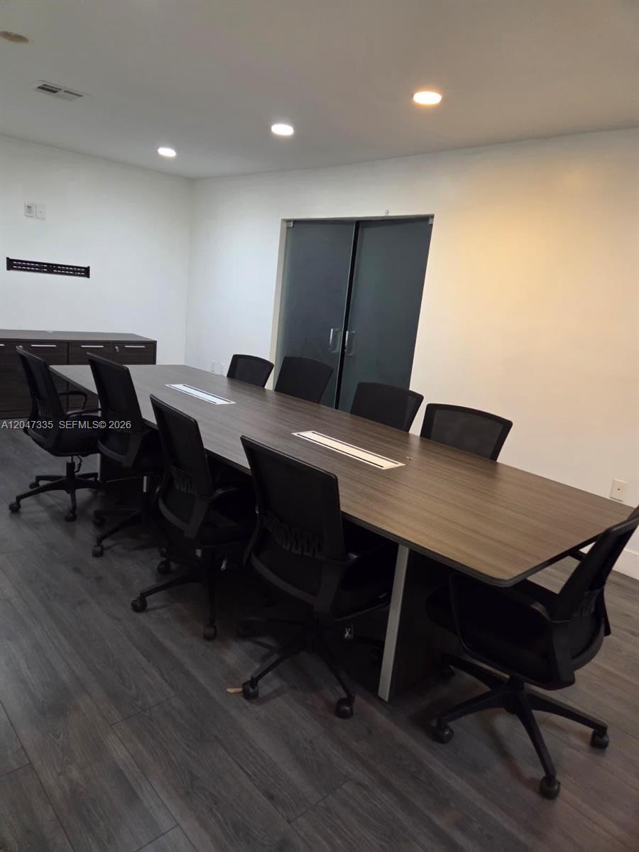 A conference room features a long wooden table, black office chairs, and dark flooring — 7274 NW 70th St, Miami FL 33166, MIAMI, FL