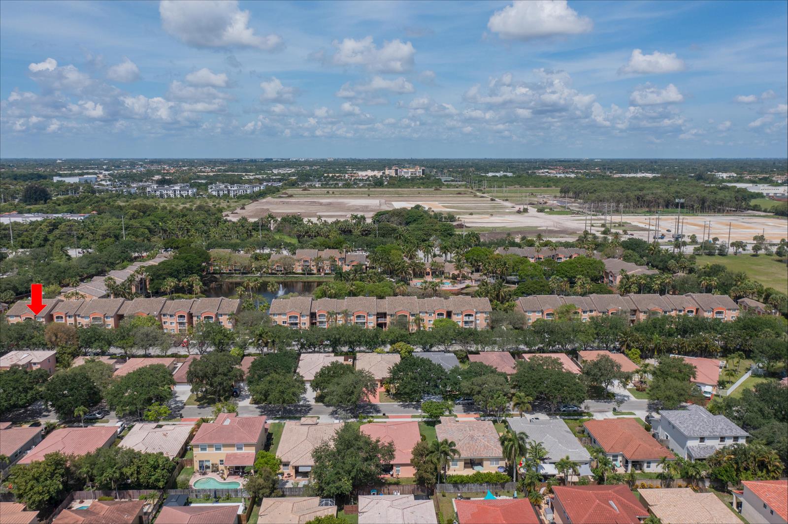 An aerial view shows a residential neighborhood with multi-story apartment buildings and single-family homes — 3844 Lyons Road # 4, Coconut Creek FL 33073, COCONUT CREEK, FL