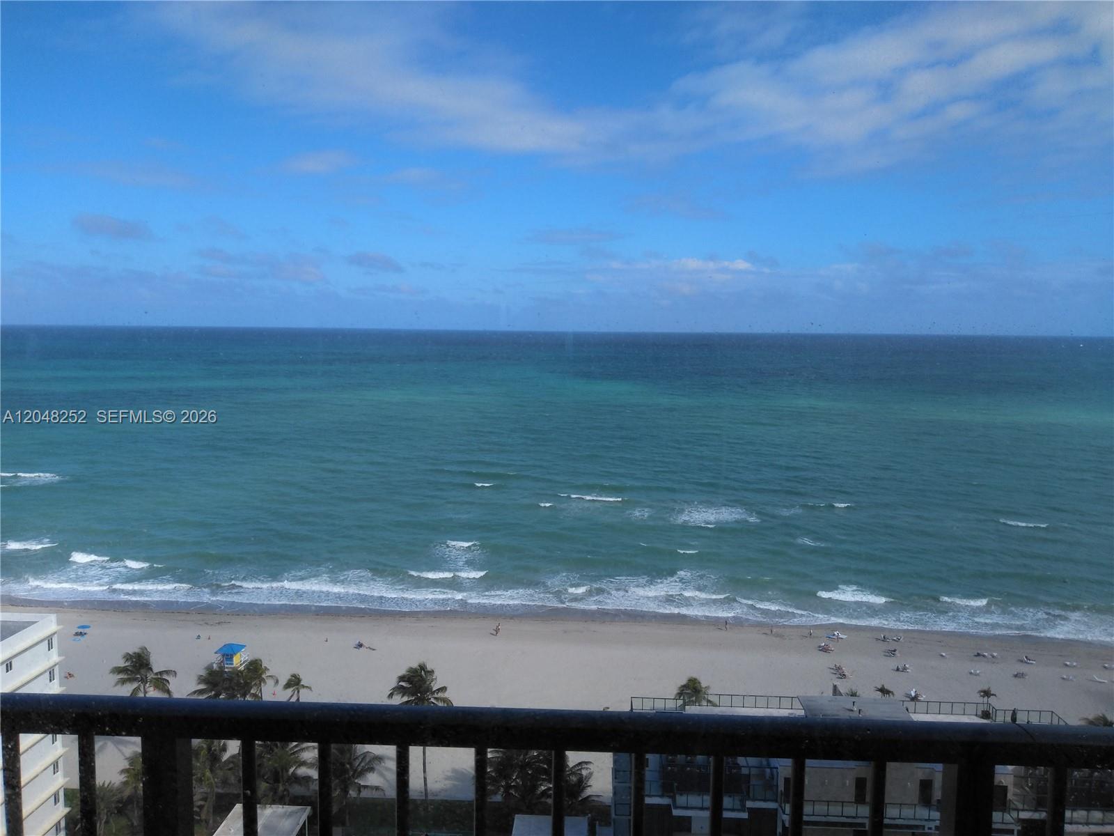 A high-angle view of a sandy beach and the ocean from a balcony — 2101 S Ocean Dr # 2001, Hollywood FL 33019, HOLLYWOOD, FL