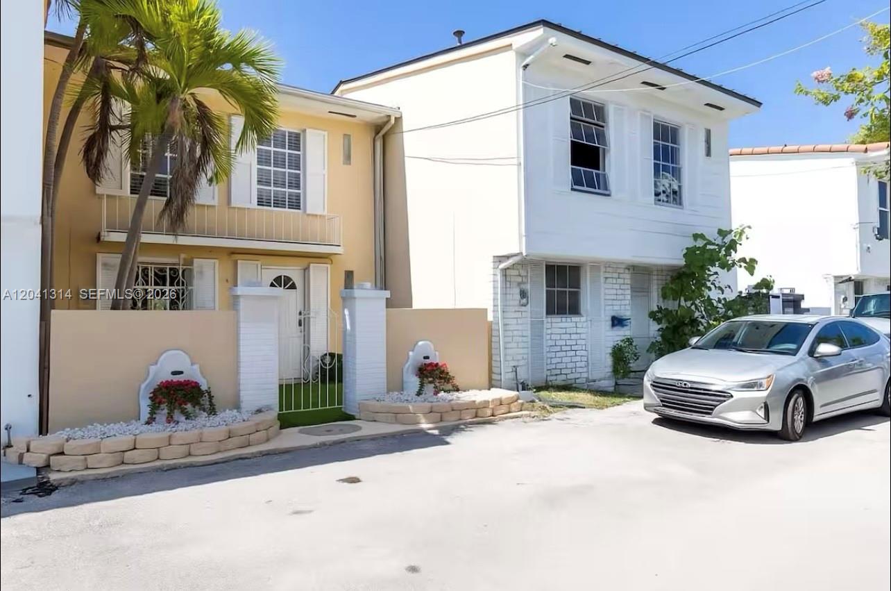 Two adjacent two-story townhouses with a palm tree and a silver car parked outside — 1949 NE 123rd St # 0, North Miami FL 33181, NORTH MIAMI, FL