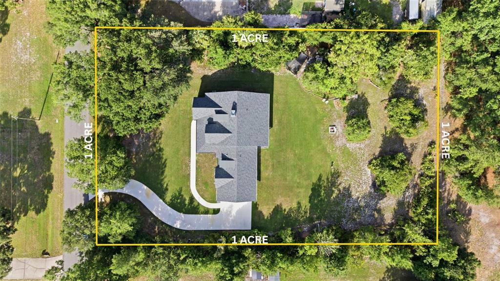 An aerial view shows a house with a driveway on a rectangular one-acre lot — 26644 EASY STREET, WESLEY CHAPEL, FL