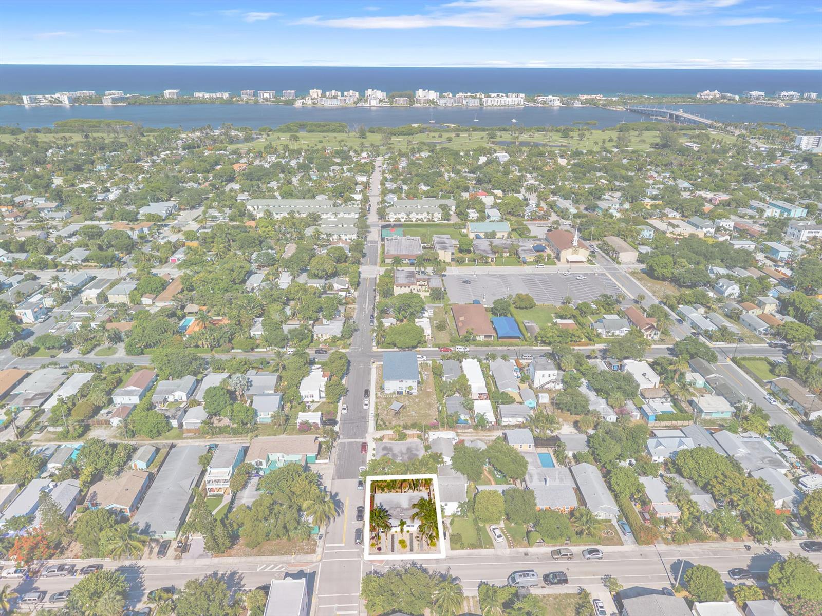An aerial view shows a residential property highlighted in a white box within a neighborhood — 430 N K Street, FL 33460, FL