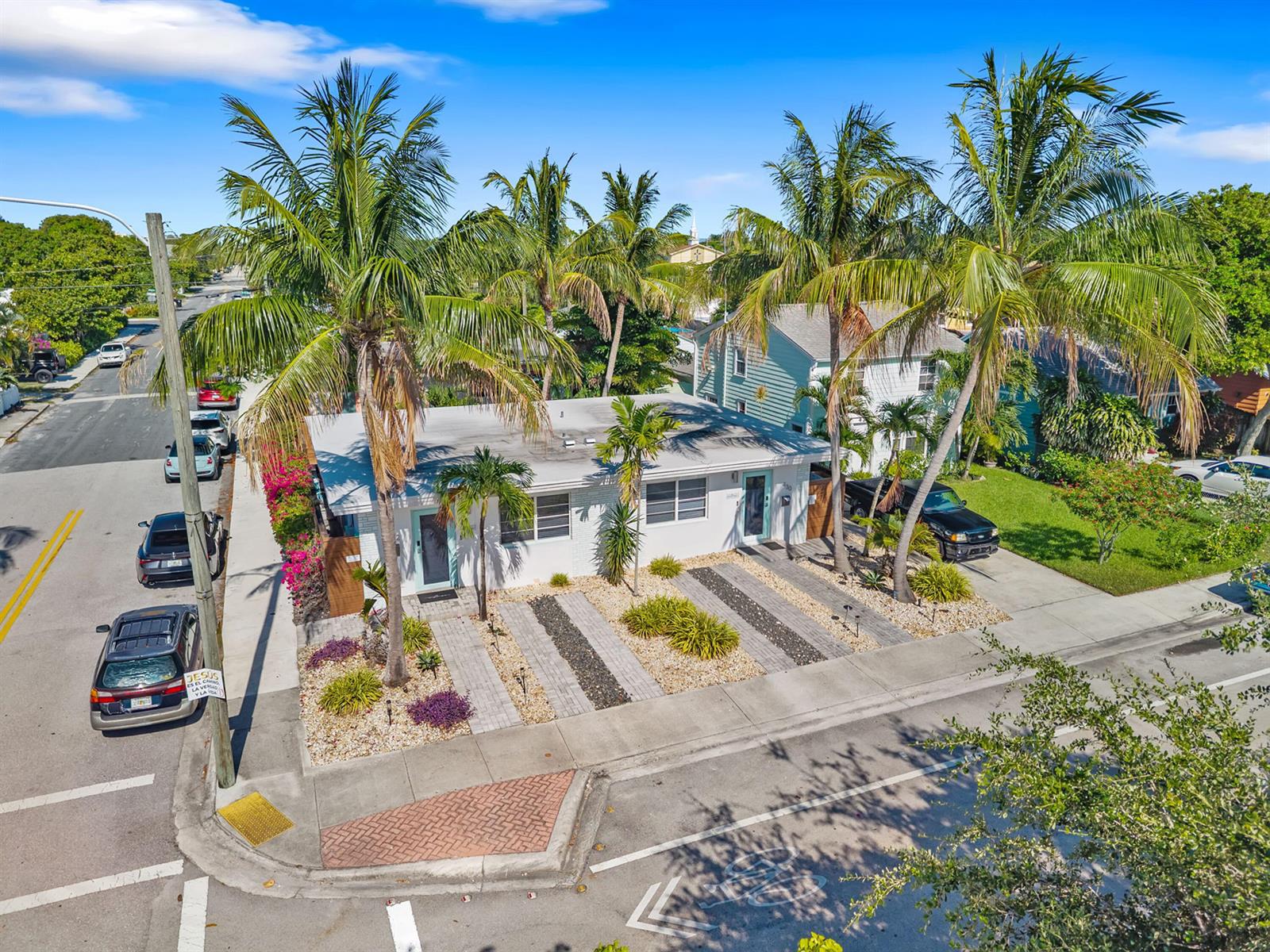 An aerial view shows a single-story duplex with palm trees and a paved driveway — 430 N K Street, FL 33460, FL