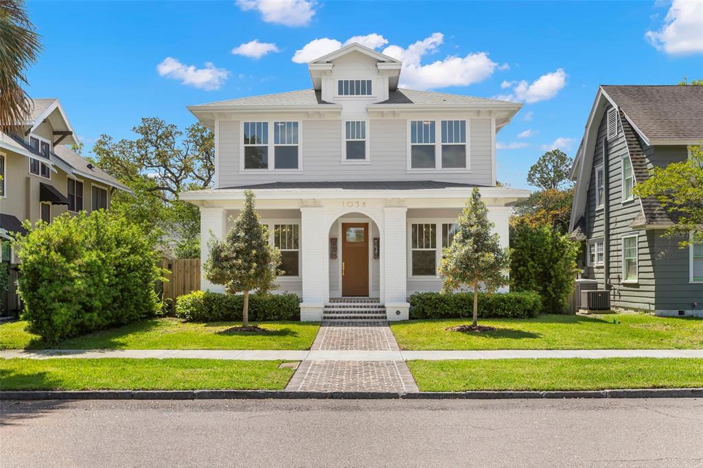 A two-story house with a white exterior, a front porch, and a brick walkway — 1038 26TH AVENUE N, ST PETERSBURG, FL