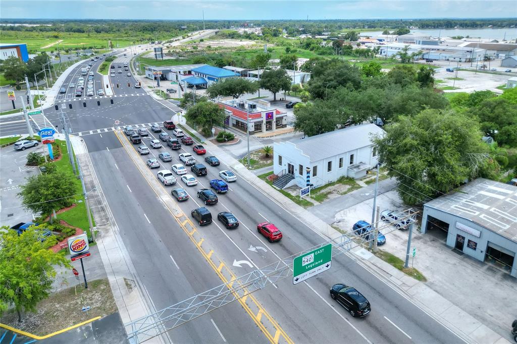 An aerial view shows a multi-lane road intersection with a Burger King and nearby buildings — 1649 3RD STREET SW, WINTER HAVEN, FL