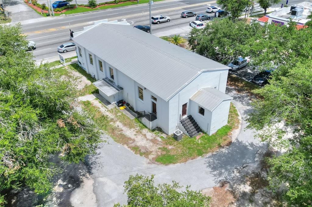 An aerial view shows a white rectangular building with a metal roof and parking lot — 1649 3RD STREET SW, WINTER HAVEN, FL