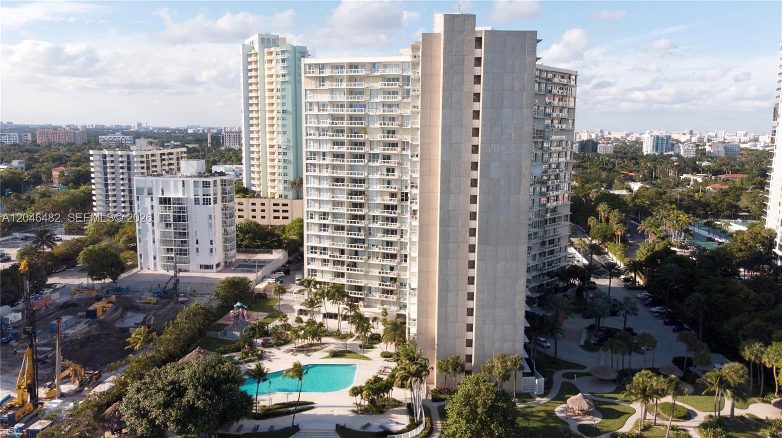 An aerial view of a tall residential apartment complex with a swimming pool and landscaping — 2451 Brickell Ave # 19B, Miami FL 33129, MIAMI, FL
